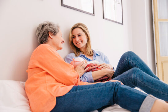 Women holding a child - postnatal care