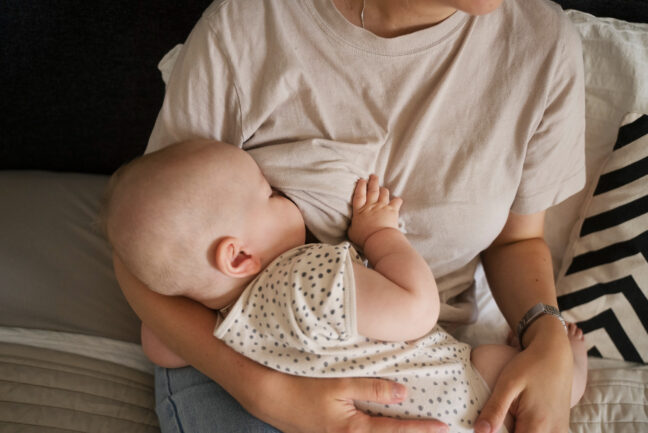 Woman Breast Feeding - Lactation Consultant